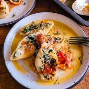 stuffed shell pasta on a plate with a fork