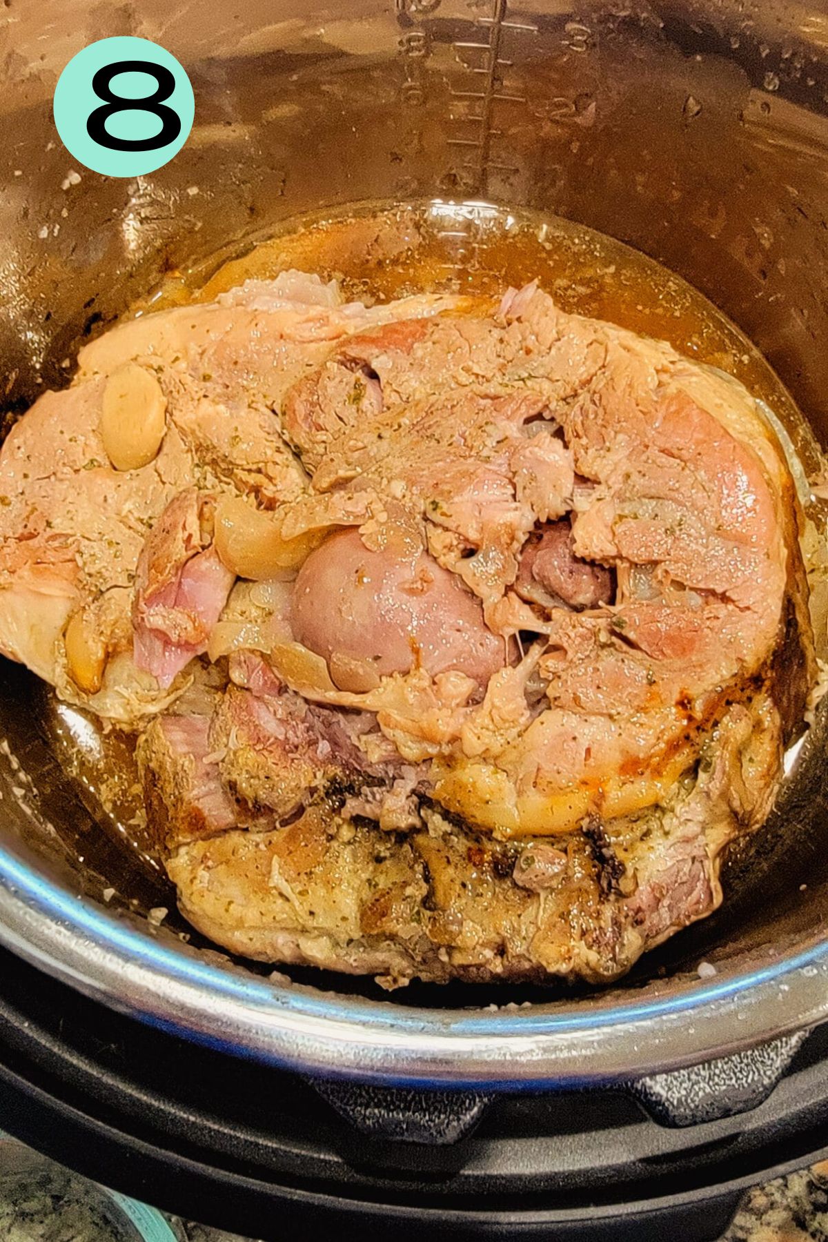 Already cooked Pernil, showing the bone and meat beginning to fall apart.
