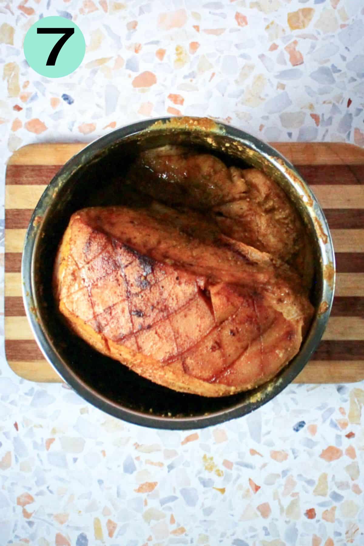 Seared cut of meat is placed inside the Instant pot liner pot.