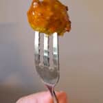A fork with a chicken meatball on its tines