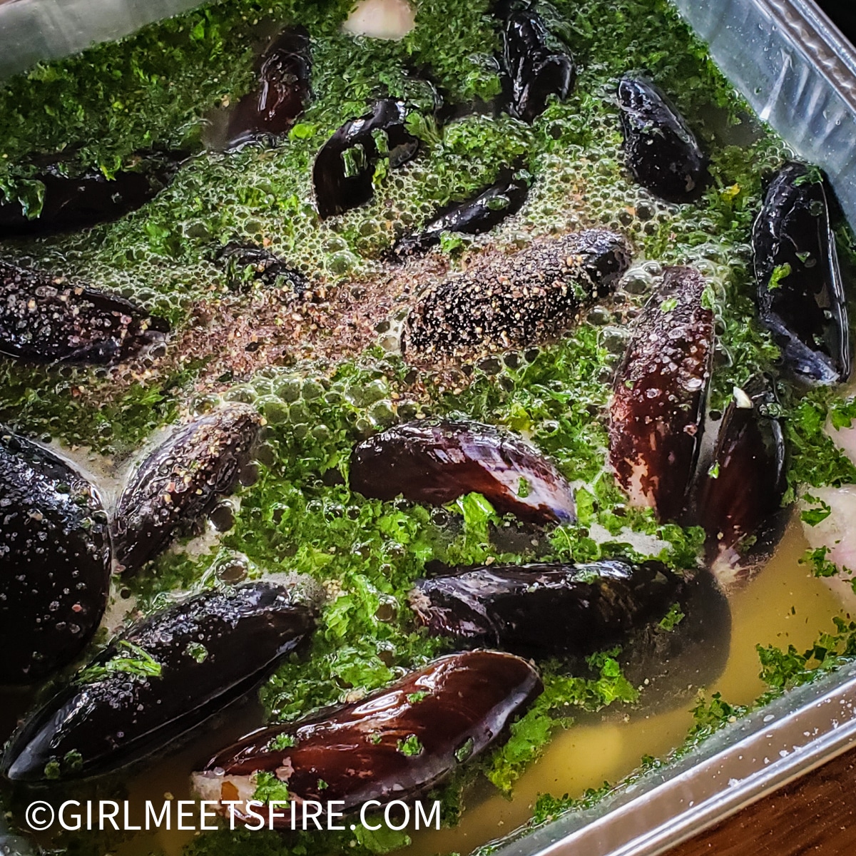 pan of mussels in marinade before cooking