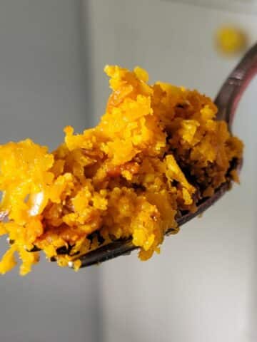 A fork full of cauliflower yellow rice.
