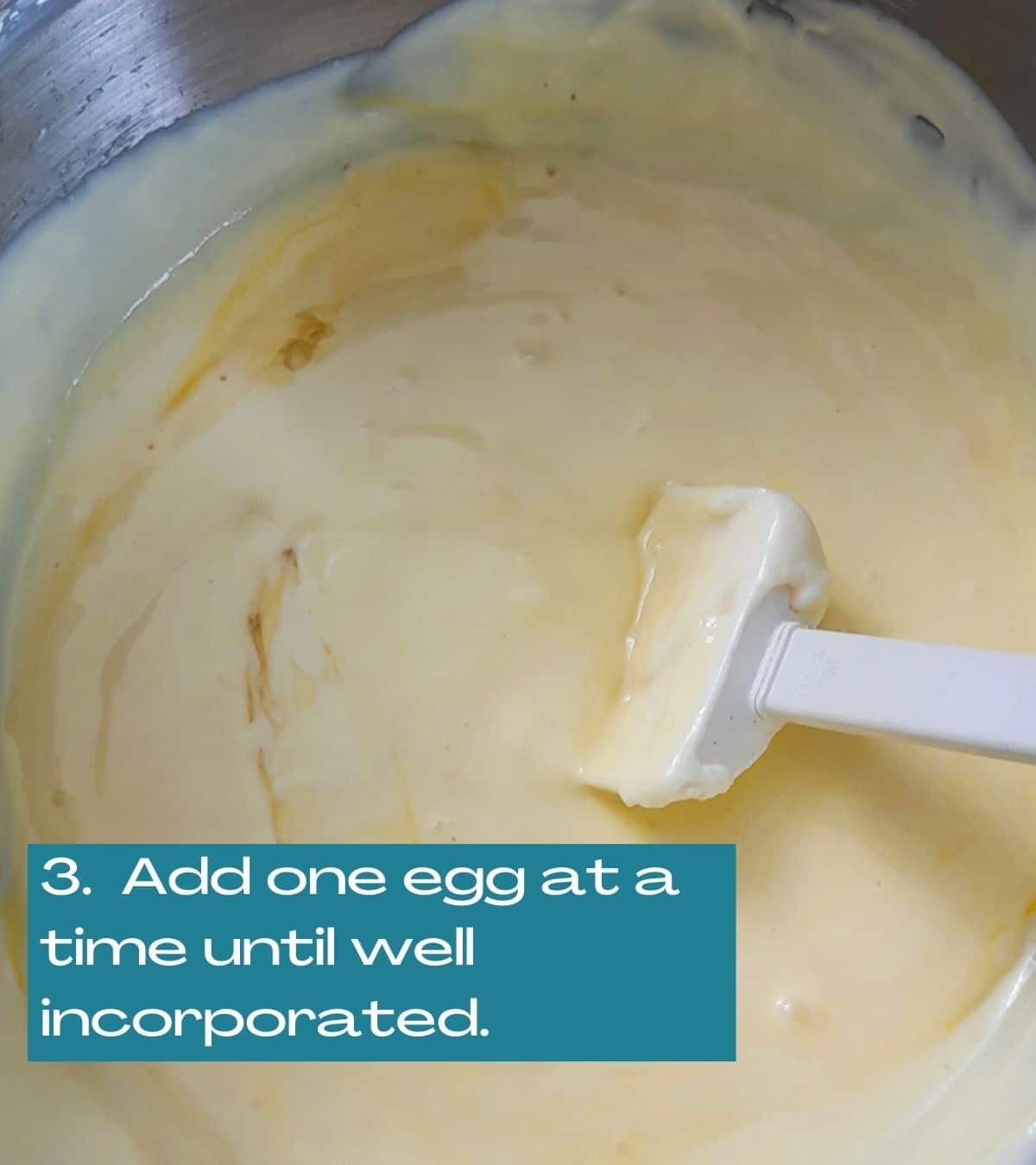 adding one egg at a time to the batter