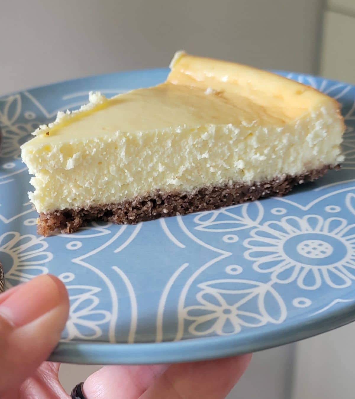 Closeup of a slice of keto-friendly pecan crusted cheesecake.