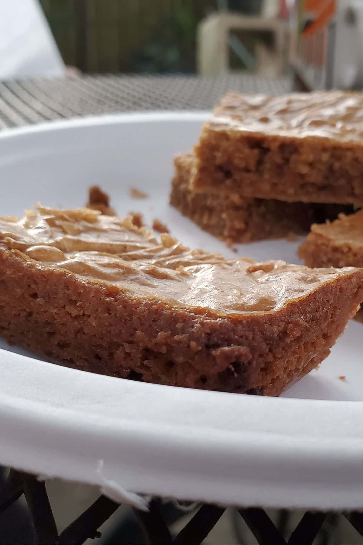 A closeup of blondies on a plate.