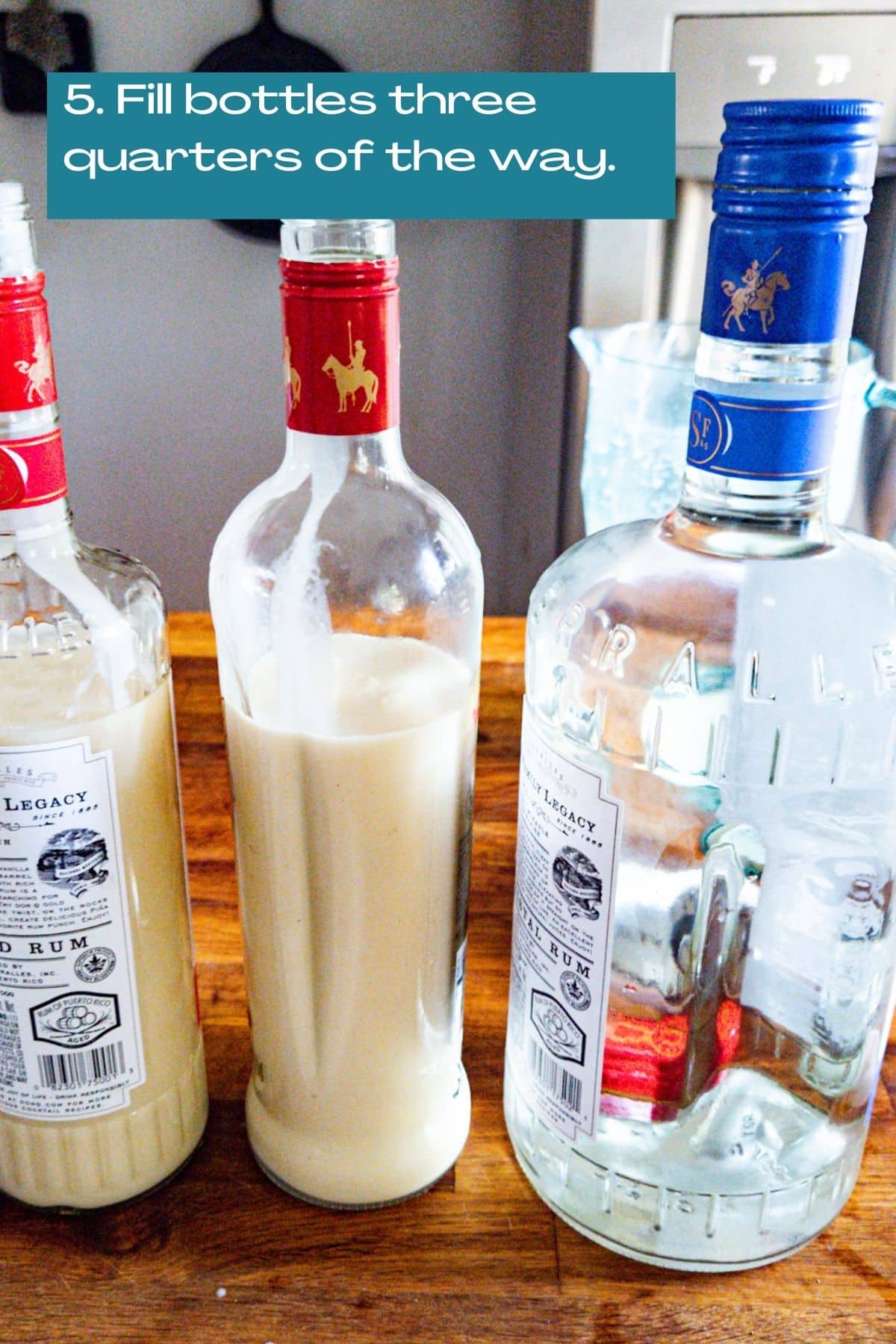 Coquito mix poured into two bottles and a bottle of white rum next to them