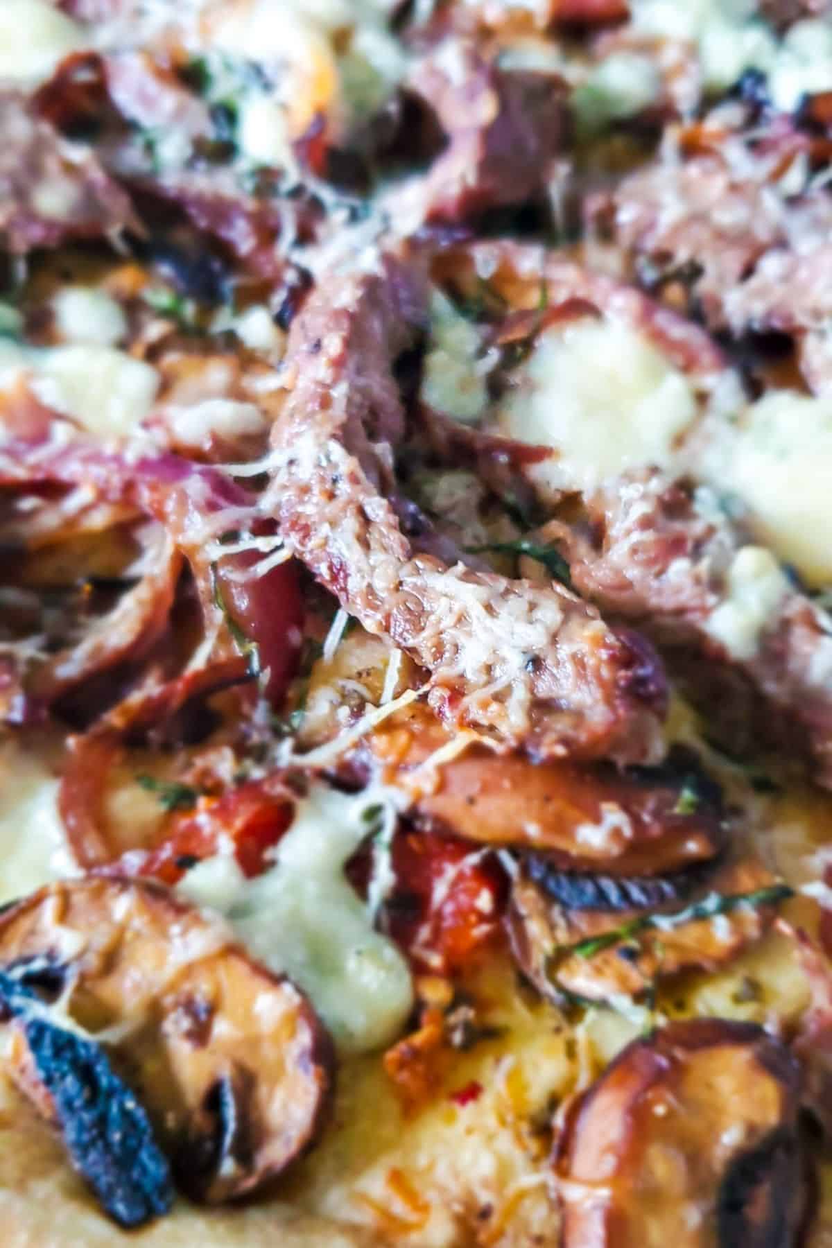 Close up of steak, Gorgonzola, and mushroom pizza