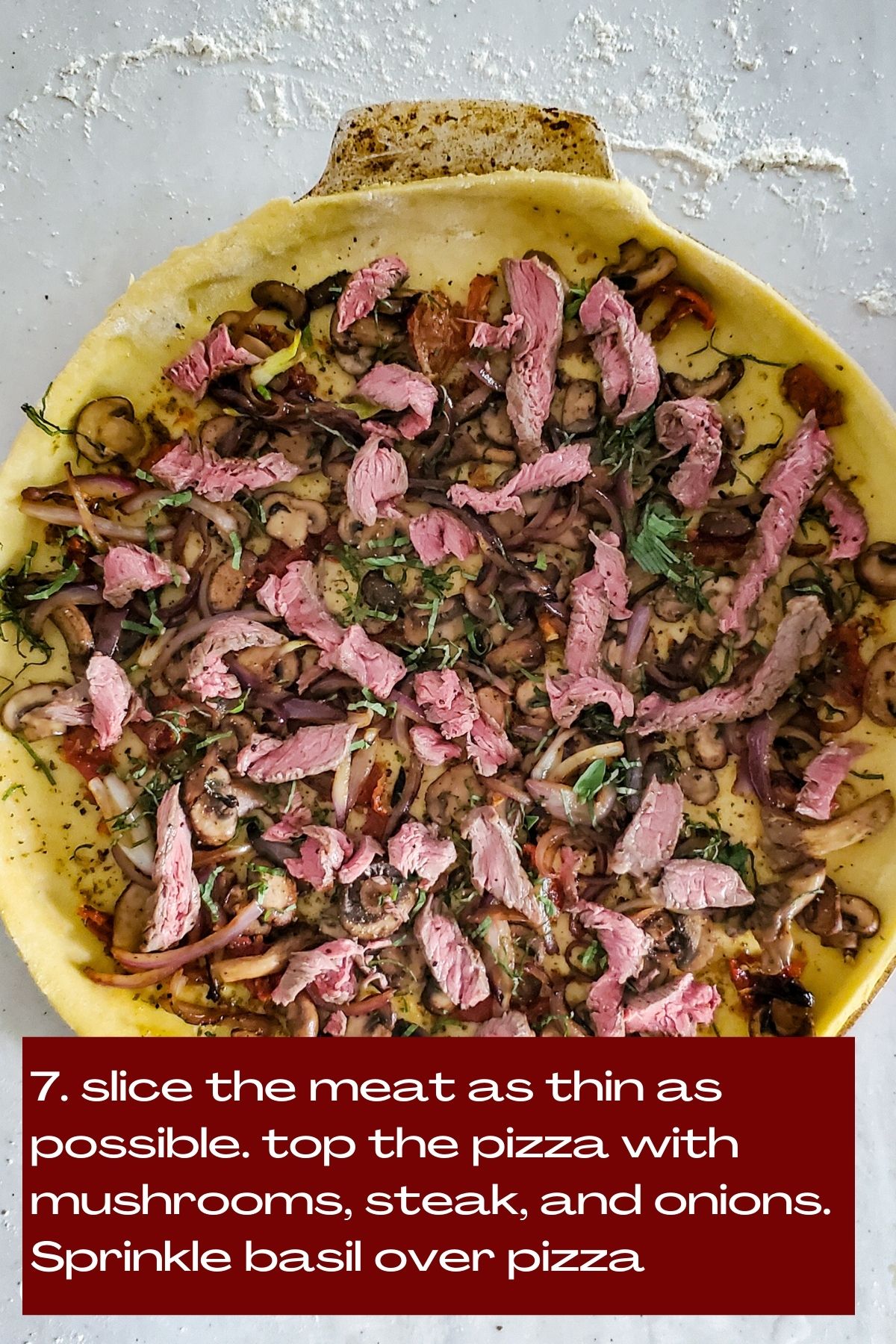 Pizzza dough topped with sautéed mushrooms, caramelized onions and strips of steak