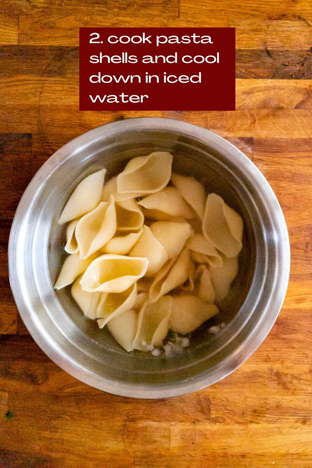 cooked shell pasta cooling in ice water.