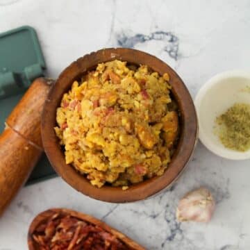 Looking down onto a wooden mortar full of mofongo.