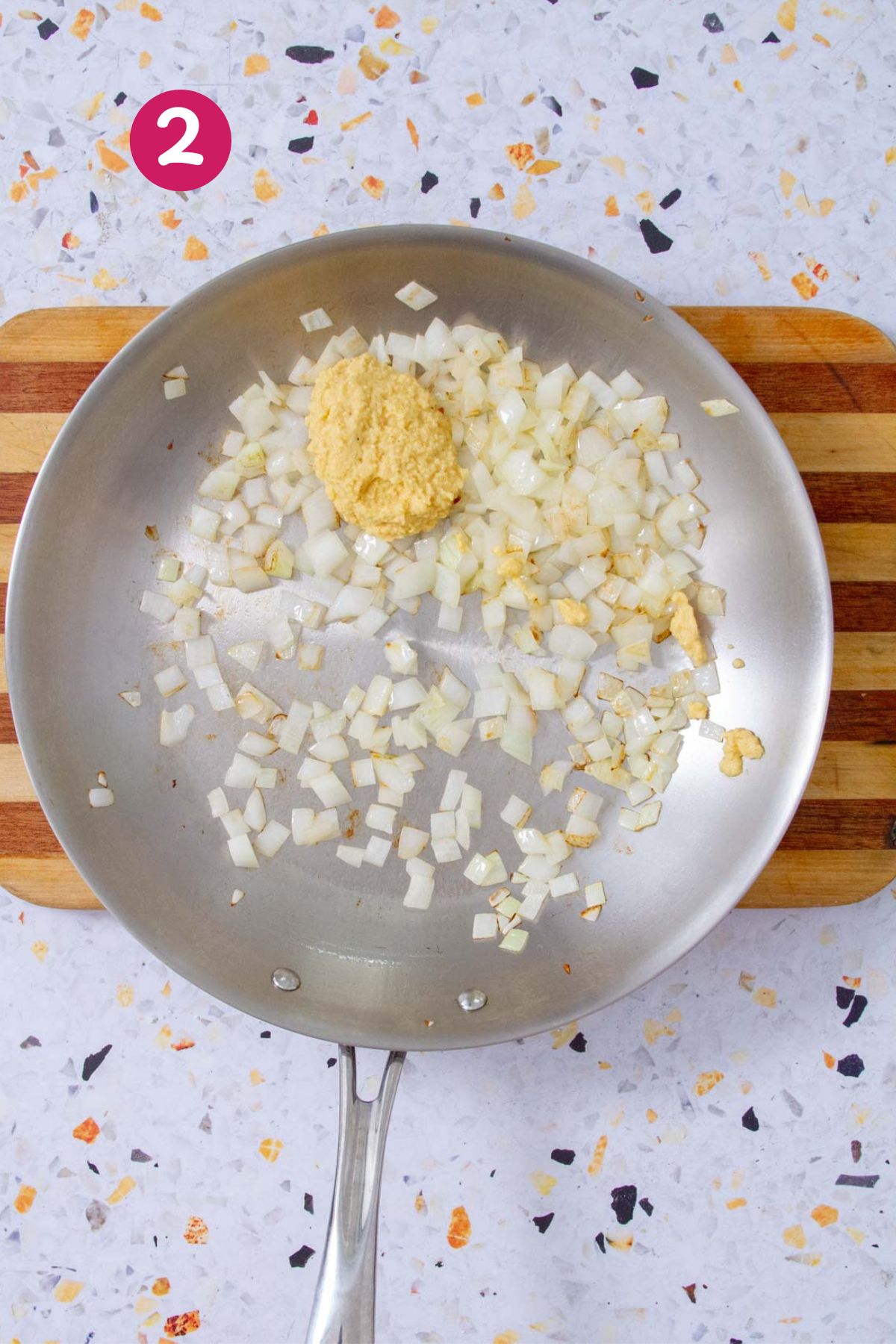 Garlic paste and diced onions sautéing in a skillet as the base of the Mojo Isleño sauce.
