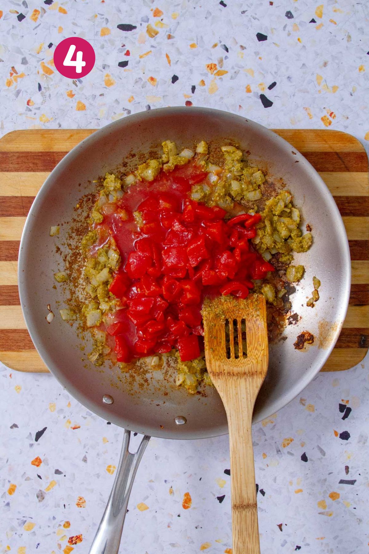 Diced tomatoes and tomato sauce added to the skillet along with sautéed onions and sofrito.