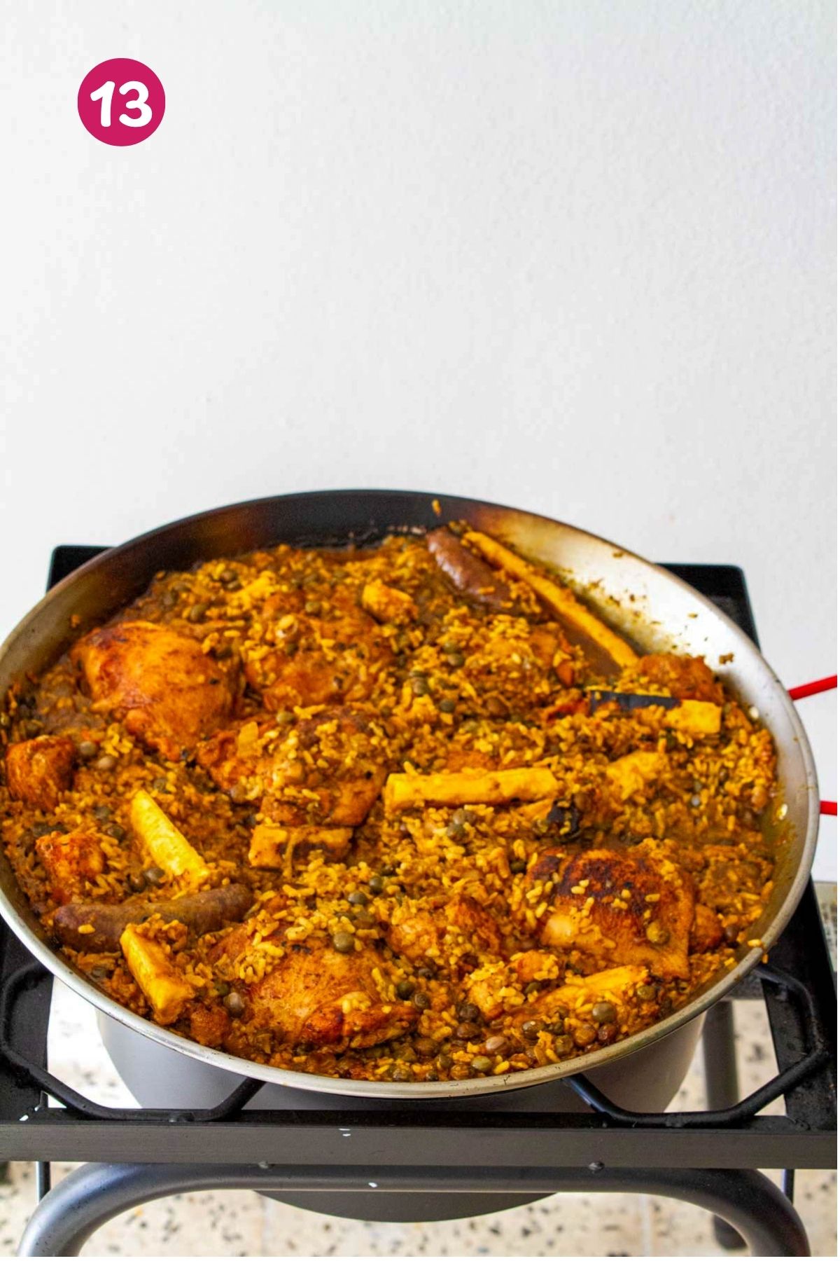 Finished Puerto Rican chicken paella with longaniza and pegao. A golden, flavorful crust at the bottom.
