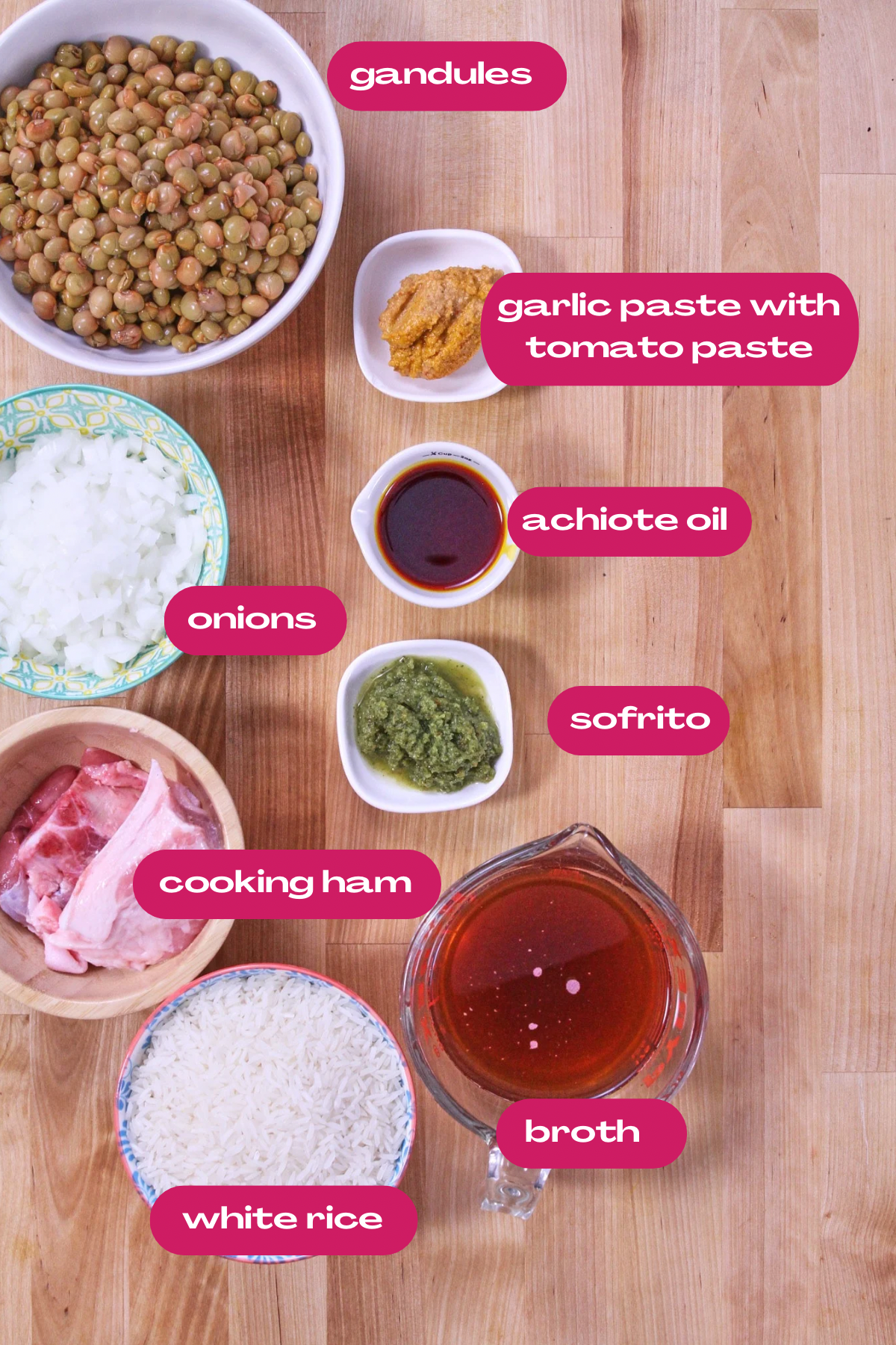 Ingredients for arroz con gandules, including rice, pigeon peas, sofrito, achiote oil, onions, cooking ham, and broth.