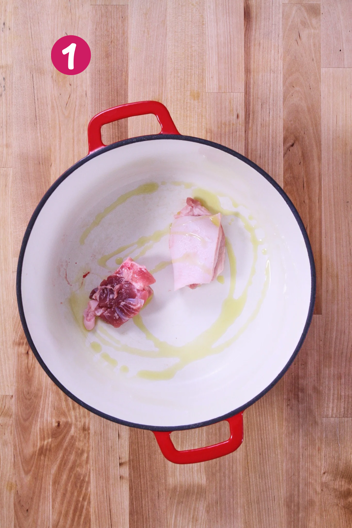 Cooking ham browning in a pot with olive oil for arroz con gandules.