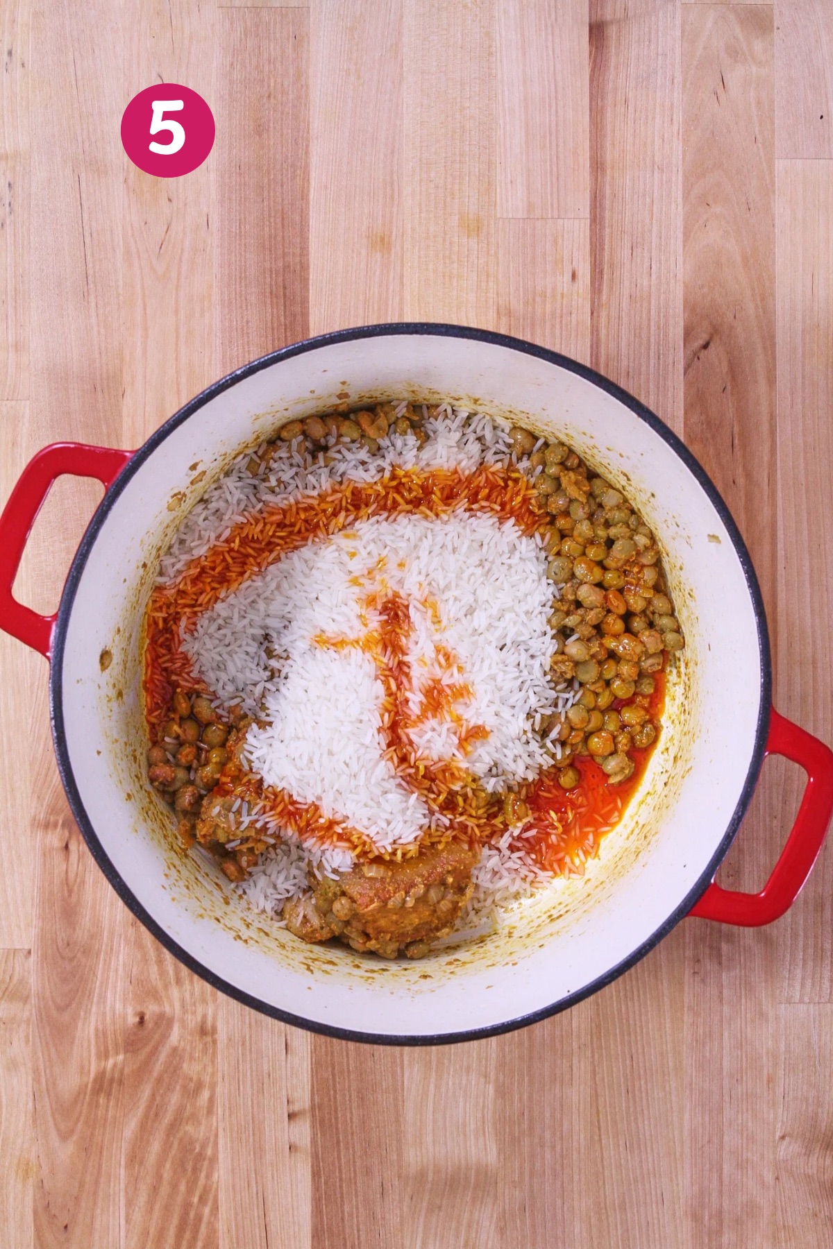 Long-grain white rice added to the post, along with achiote oil.