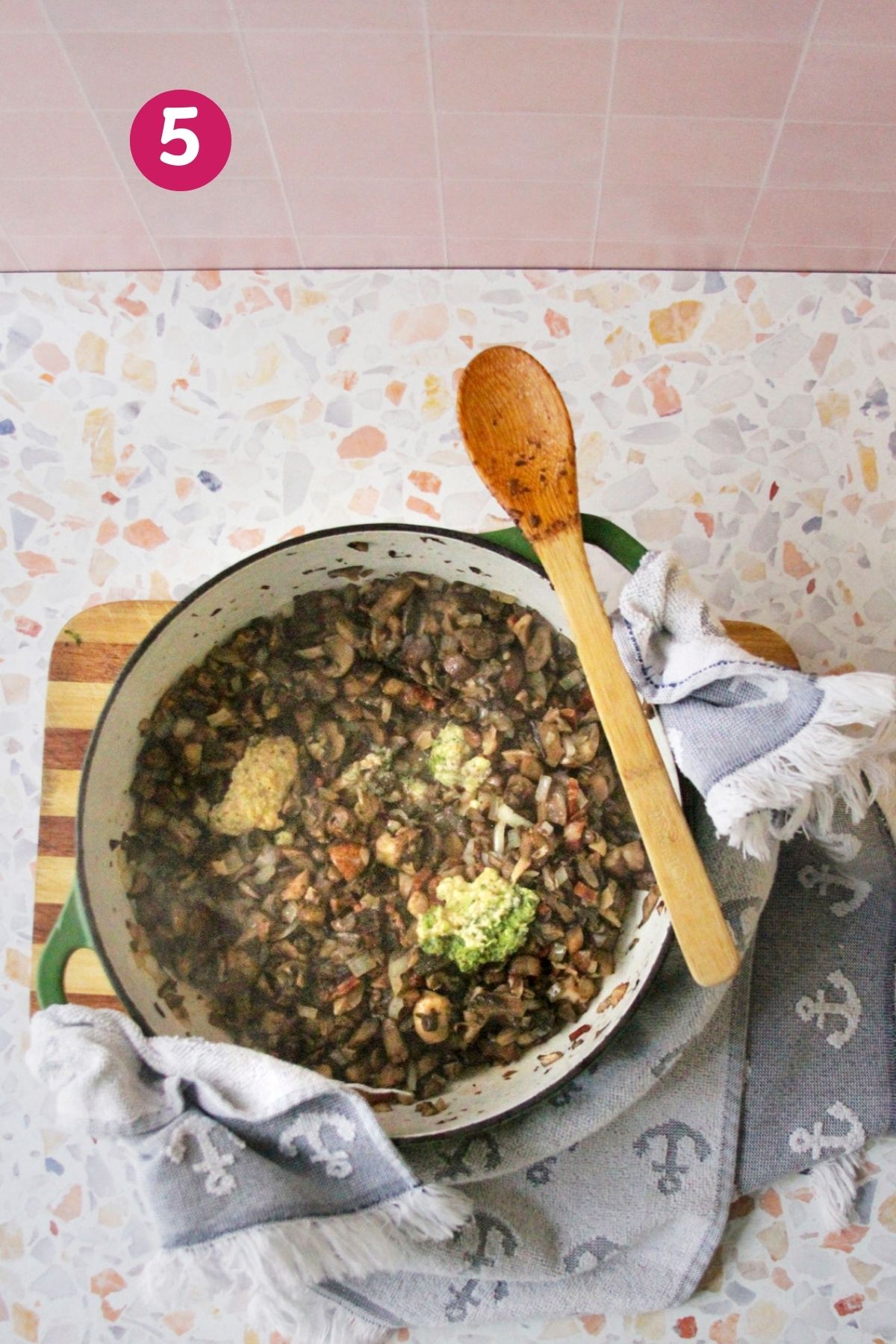 Chopped mushrooms and diced onions were added to a Dutch oven with cooked bacon, photographed from overhead.