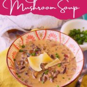 Bowl of bacon mushroom soup garnished with shaved cheese and chopped chives on a yellow napkin, with text overlay reading “Smoky and Earthy Bacon Mushroom Soup” and website URL at the bottom.