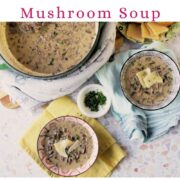 Overhead scene of bacon mushroom soup in a green Dutch oven with two bowls of soup, bread slices, and chopped herbs, with text overlay reading “Creamy Bacon Mushroom Soup” and “get the recipe” with website text below.