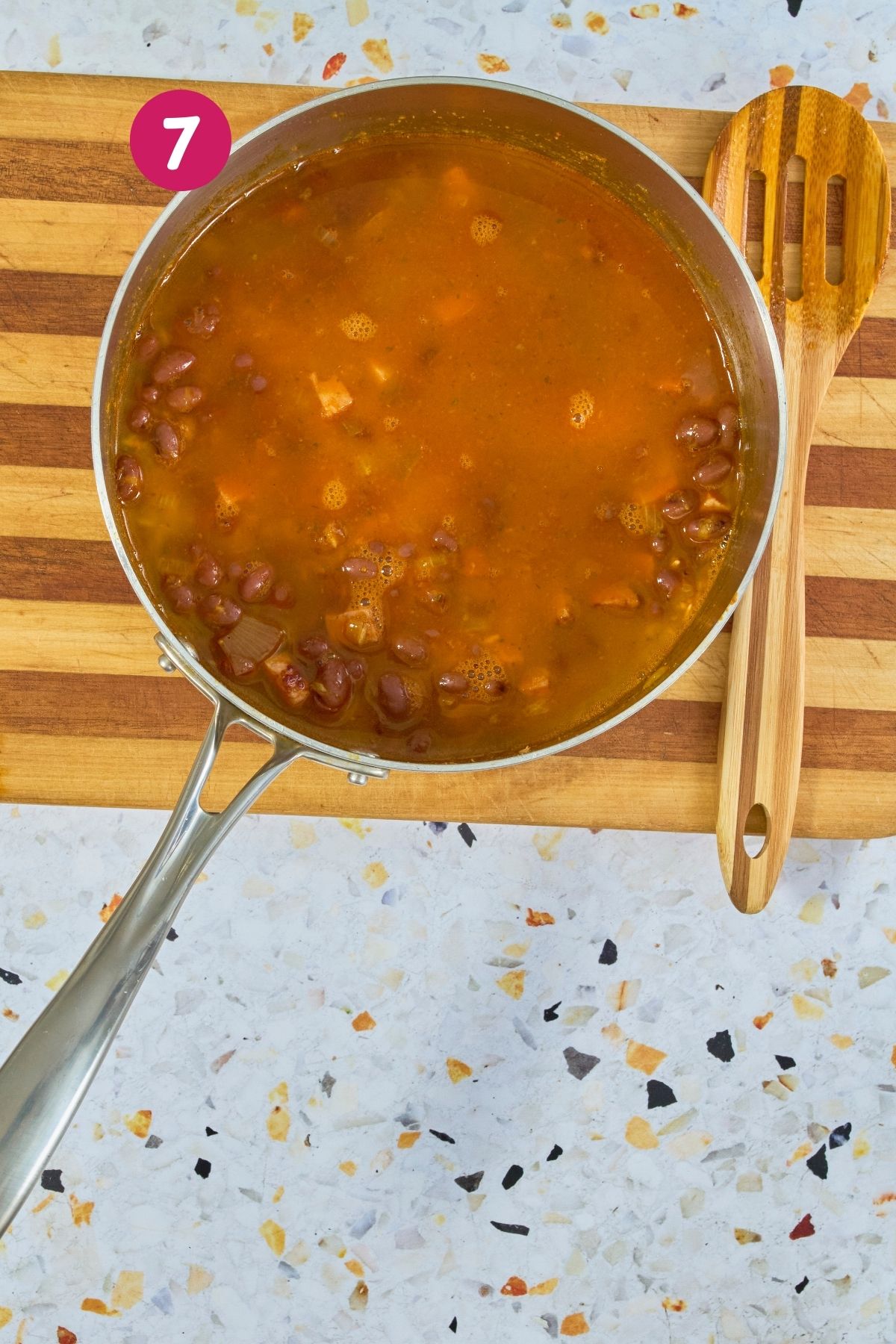 Pot of rice with beans and broth, along with all the other ingredients.