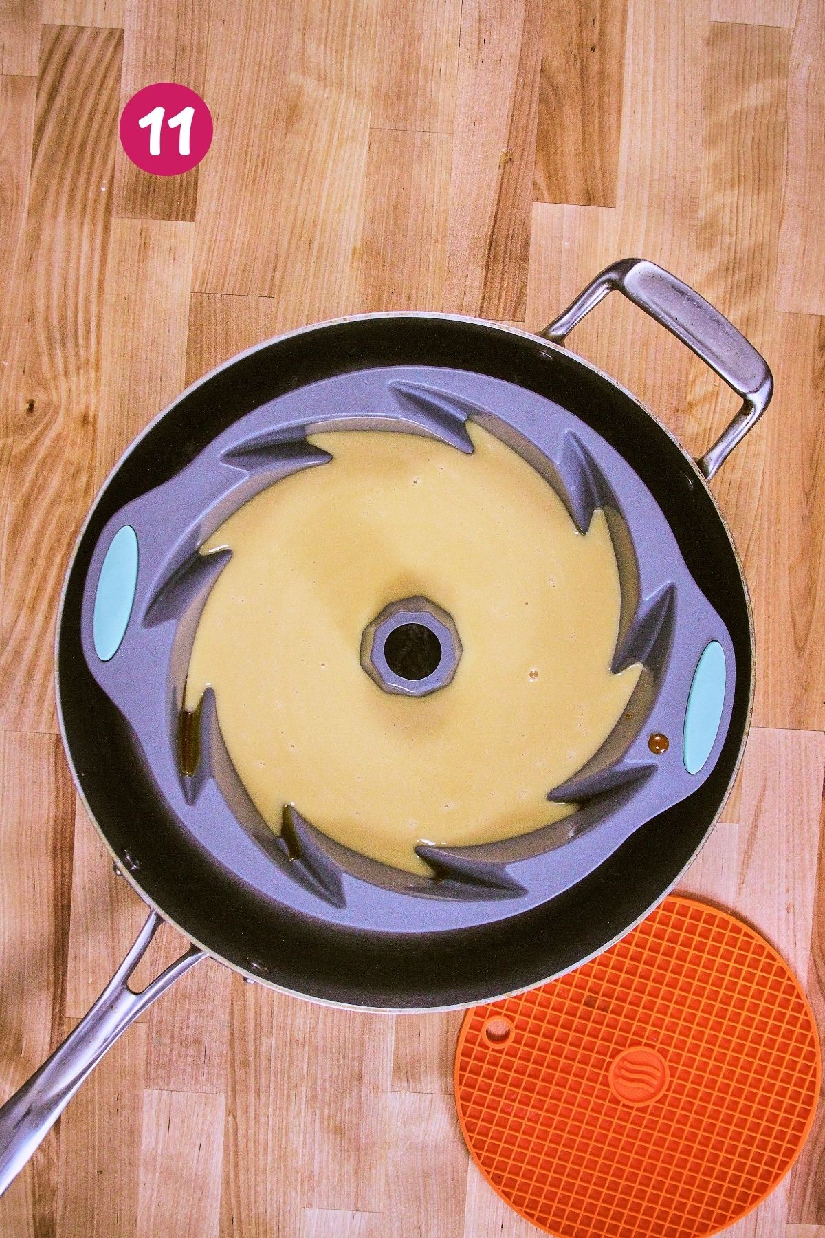 Smooth vanilla flan custard poured into a silicone bundt mold over the caramel layer, set inside a braiser for the water bath.