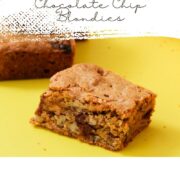 Peanut butter chocolate chip blondie square on a yellow surface with a white top section and script text reading "Chewy and Buttery Classic Peanut Butter Chocolate Chip Blondies" with decorative leaf accents and girlmeetsfire.com.