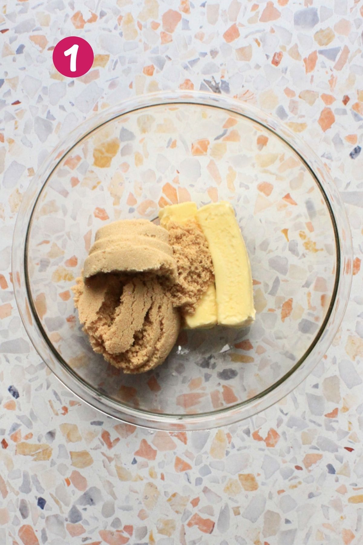 Brown sugar and butter in a glass bowl before creaming, the first step for hojaldre añasqueño, Puerto Rican spice cake.