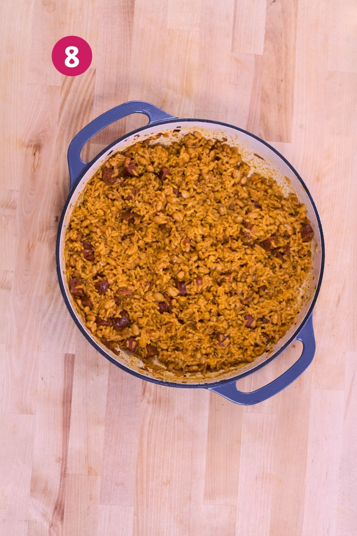 Finished arroz con chorizo y habichuelas blancas in a Dutch oven after steaming.