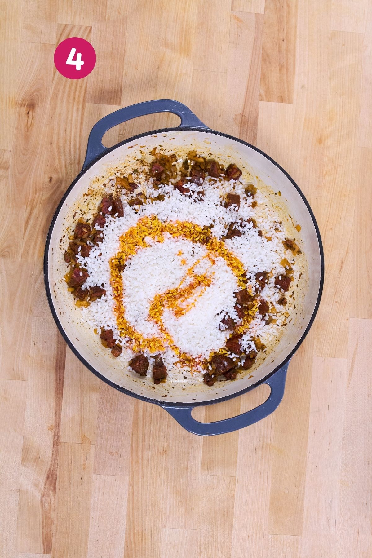 Rice and achiote oil were added to the chorizo-and-ham mixture in a Dutch oven.